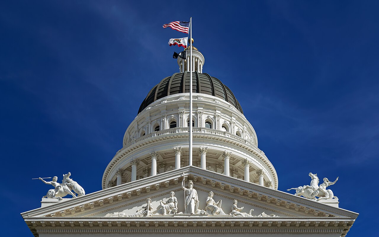 The dome and pediment of the California State Capitol in Sacramento, seen from below